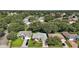 Aerial view of the charming home surrounded by lush greenery and a well-manicured lawn at 4904 Long Meadow Dr, Leesburg, FL 34748