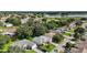 Serene aerial view of a residential community near a golf course, lush landscape, and shimmering lake at 4904 Long Meadow Dr, Leesburg, FL 34748