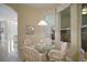 Charming breakfast nook featuring a glass table, wicker chairs, and abundant natural light at 4904 Long Meadow Dr, Leesburg, FL 34748