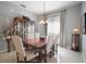 Formal dining room showcasing a wood table, upholstered chairs, and a decorative china cabinet at 4904 Long Meadow Dr, Leesburg, FL 34748