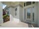 Covered home entryway with an ornate glass door and manicured landscaping at 4904 Long Meadow Dr, Leesburg, FL 34748