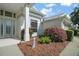 Inviting home entrance with a well-manicured garden and decorative accents at 4904 Long Meadow Dr, Leesburg, FL 34748