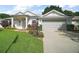 Charming single-story home with a well-manicured lawn and an attached two-car garage at 4904 Long Meadow Dr, Leesburg, FL 34748