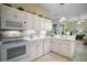 Bright kitchen with white cabinets, modern appliances, and sleek countertops at 4904 Long Meadow Dr, Leesburg, FL 34748
