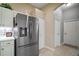 Kitchen with stainless steel refrigerator, white cabinets, and updated appliances at 4904 Long Meadow Dr, Leesburg, FL 34748