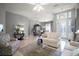 Elegant living room with tile floors, stylish decor, and a view into the formal dining area at 4904 Long Meadow Dr, Leesburg, FL 34748