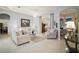 Well-lit living room with tile floors, ceiling fan, and multiple archways to other rooms at 4904 Long Meadow Dr, Leesburg, FL 34748