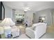 Bright living room with neutral paint, ceiling fan, and a glimpse into the dining area at 4904 Long Meadow Dr, Leesburg, FL 34748