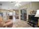 Spacious living room with a view into the kitchen and breakfast nook through large sliding doors at 4904 Long Meadow Dr, Leesburg, FL 34748
