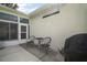 Relaxing patio area with seating, a grill, and a view of the well-maintained backyard at 4904 Long Meadow Dr, Leesburg, FL 34748