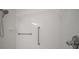 Shower featuring white tiles, safety bar, shower head and shower handle at 4904 Long Meadow Dr, Leesburg, FL 34748