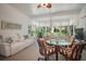 Bright sunroom with large windows, comfortable seating, and a view of the landscaped yard at 4904 Long Meadow Dr, Leesburg, FL 34748