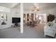Open sunroom featuring large windows, comfortable seating, and a view of the landscaped yard at 4904 Long Meadow Dr, Leesburg, FL 34748