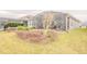 View of the backyard with a screened-in patio and well-manicured landscaping at 525 Narrow View Ln, Groveland, FL 34736
