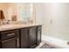 Bathroom featuring a glass enclosed shower, granite countertop with dual sinks, and modern fixtures at 525 Narrow View Ln, Groveland, FL 34736