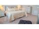 Cozy bedroom with soft carpet, a comfortable bed with decorative pillows, and matching nightstands at 525 Narrow View Ln, Groveland, FL 34736