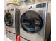 Laundry area featuring modern stainless-steel washer and dryer with front loading design at 525 Narrow View Ln, Groveland, FL 34736