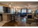 Open concept living space with kitchen, dining area, hardwood floors and comfortable seating at 525 Narrow View Ln, Groveland, FL 34736