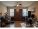 Home office with a wall bed system, hardwood flooring, and functional workspace at 525 Narrow View Ln, Groveland, FL 34736