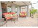 Covered patio with brick pavers, comfortable seating, throw pillows, and ceiling fan at 525 Narrow View Ln, Groveland, FL 34736