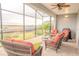 Screened patio area with brick pavers, comfortable seating, outdoor furniture, and pleasant view at 525 Narrow View Ln, Groveland, FL 34736