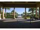 View of a luxurious pool area with palm trees and umbrella shaded lounge chairs at 525 Narrow View Ln, Groveland, FL 34736