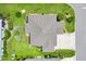 Aerial view of the home showcasing its layout, roof, landscaping, and proximity to the street at 5311 Eads Ter, The Villages, FL 32163
