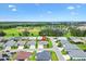 Aerial view of the property in a neighborhood with mature trees and baseball park nearby at 5311 Eads Ter, The Villages, FL 32163