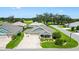 Aerial view of a charming single-story home with a three-car garage in a well-kept neighborhood at 5311 Eads Ter, The Villages, FL 32163