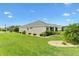 Well-maintained backyard featuring lush green grass, manicured shrubbery, and mature landscaping at 5311 Eads Ter, The Villages, FL 32163