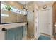 Bright bathroom showcases a glass enclosed shower, a small window and neutral tile at 5311 Eads Ter, The Villages, FL 32163
