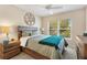 Inviting bedroom features a wooden frame bed, comfy linens, and a large sunlit window at 5311 Eads Ter, The Villages, FL 32163