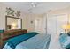 Comfortable bedroom with cool toned linens, dresser and closet at 5311 Eads Ter, The Villages, FL 32163