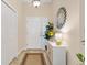 Bright foyer with a decorative mirror and a console table adds elegance to the entrance at 5311 Eads Ter, The Villages, FL 32163