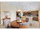 Bright kitchen with breakfast bar and stainless steel appliances is open to the dining area at 5311 Eads Ter, The Villages, FL 32163