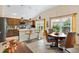 Lovely kitchen with stainless steel appliances, eat in bar, adjacent dining area and light, neutral color palette at 5311 Eads Ter, The Villages, FL 32163