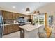 Kitchen with stainless steel appliances, tile backsplash, and breakfast bar featuring pendant lighting at 5311 Eads Ter, The Villages, FL 32163