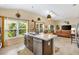 Spacious kitchen island overlooks the living and dining areas and features stainless steel appliances and bar seating at 5311 Eads Ter, The Villages, FL 32163