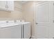 Bright laundry room features a white washer, white dryer and white cabinets at 5311 Eads Ter, The Villages, FL 32163
