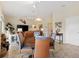 Open living room featuring a dining table, television, and a sliding glass door at 5311 Eads Ter, The Villages, FL 32163