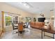 Open concept living room features tile floors, lots of natural light, comfortable seating and access to lanai at 5311 Eads Ter, The Villages, FL 32163