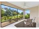 Enclosed patio featuring seating area, ceiling fan, and beautiful landscape views at 5311 Eads Ter, The Villages, FL 32163