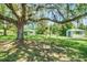 Lush backyard with a large shade tree and a storage shed, creating a peaceful outdoor space at 5319 Eagles Nest Rd, Fruitland Park, FL 34731