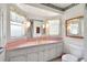 Bathroom features a single sink vanity with white cabinets and a pink countertop at 5319 Eagles Nest Rd, Fruitland Park, FL 34731