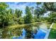 Picturesque canal view surrounded by lush greenery, offering a tranquil waterfront setting at 5319 Eagles Nest Rd, Fruitland Park, FL 34731