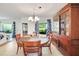 Formal dining room features a chandelier, hardwood furniture, and large display cabinet at 5319 Eagles Nest Rd, Fruitland Park, FL 34731