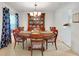 Bright dining room featuring a wood table, china cabinet, and blue patterned curtains at 5319 Eagles Nest Rd, Fruitland Park, FL 34731