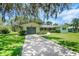 Charming single-story home with a well-manicured lawn and a long driveway leading to the garage at 5319 Eagles Nest Rd, Fruitland Park, FL 34731
