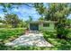 Garage with a concrete pathway and green lawn in front at 5319 Eagles Nest Rd, Fruitland Park, FL 34731