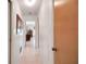 Bright hallway with tile flooring, featuring doors leading to various rooms in the home at 5319 Eagles Nest Rd, Fruitland Park, FL 34731